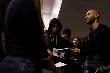 Carlos Malave '11 signs copies of his book.